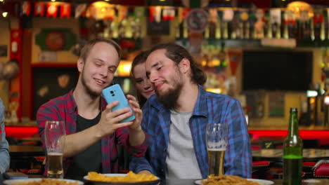 In-the-Bar-or-Restaurant-Hispanic-man-Takes-Selfie-of-Herself-and-Her-Best-Friends.-Group-Beautiful-Young-People-in-Stylish-Establishment.